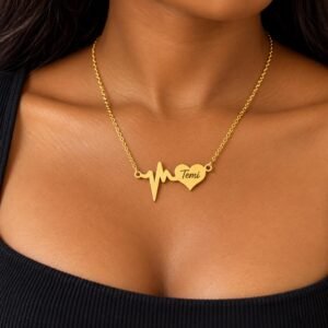 Personalized gold heartbeat necklace with custom name on a heart pendant worn by a female model